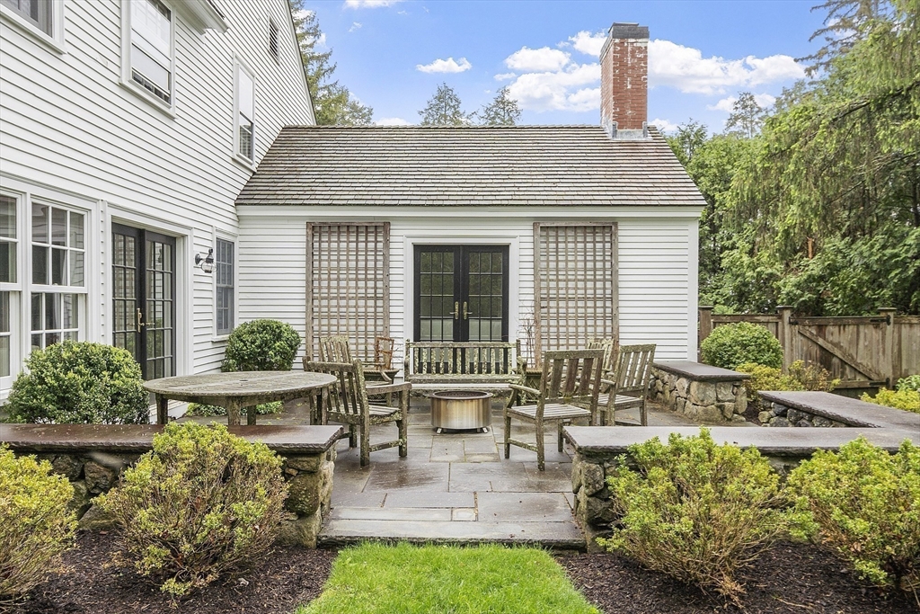 90 Coolidge Road Concord, MA 01742 - Photo 13 of 42 a front view of a house with patio