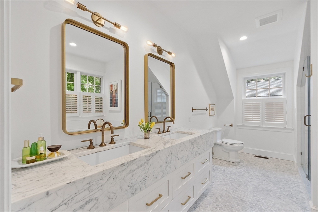 90 Coolidge Road Concord, MA 01742 - Photo 19 of 42 a bathroom with a granite countertop sink mirror and a bathtub