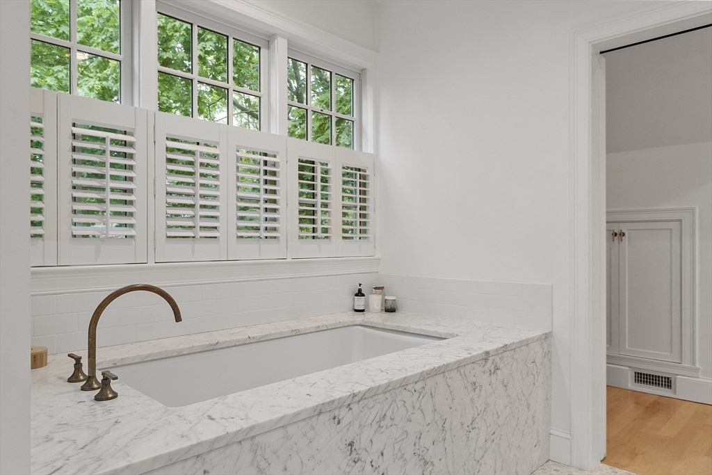90 Coolidge Road Concord, MA 01742 - Photo 20 of 42 a bath tub sitting in a bathroom next to a window