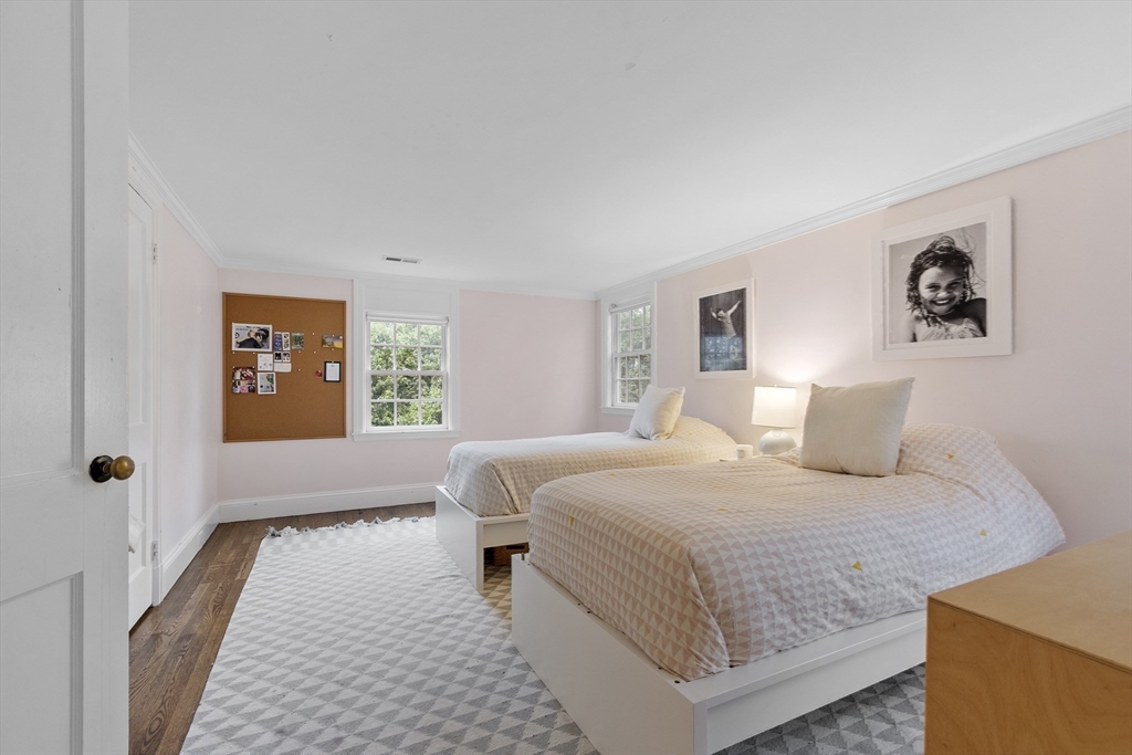 90 Coolidge Road Concord, MA 01742 - Photo 23 of 42 a bedroom with a large bed and a window