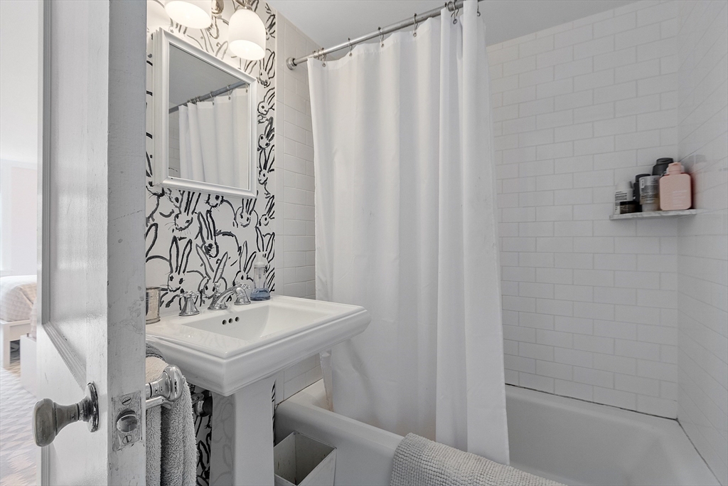 90 Coolidge Road Concord, MA 01742 - Photo 25 of 42 a bathroom with a sink a toilet and a mirror