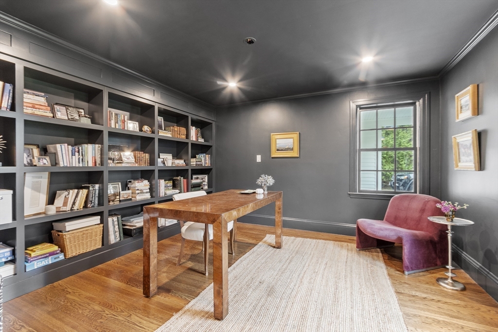 90 Coolidge Road Concord, MA 01742 - Photo 31 of 42 a living room with furniture a bookshelf and a window