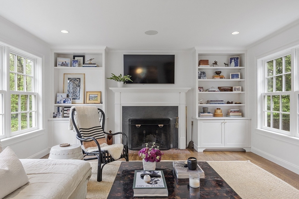 90 Coolidge Road Concord, MA 01742 - Photo 33 of 42 a living room with furniture and a fireplace