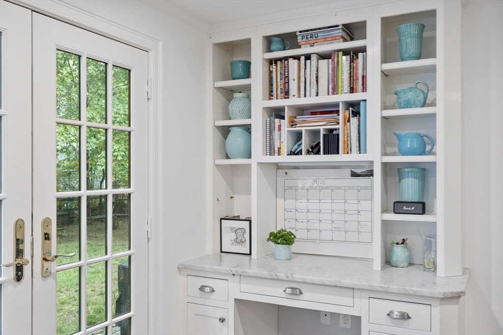 90 Coolidge Road Concord, MA 01742 - Photo 35 of 42 a shelf with books and knick knacks on it