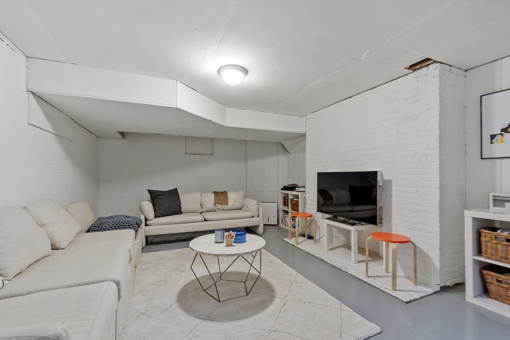 90 Coolidge Road Concord, MA 01742 - Photo 36 of 42 a living room with furniture and a flat screen tv
