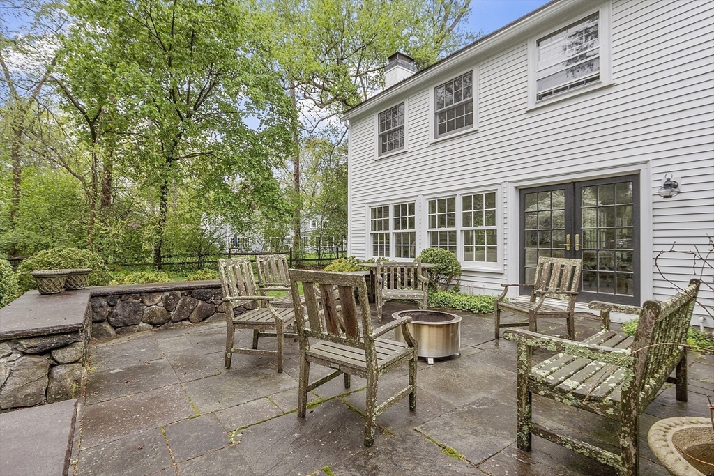 90 Coolidge Road Concord, MA 01742 - Photo 39 of 42 a view of a patio with a dining table and chairs with wooden floor