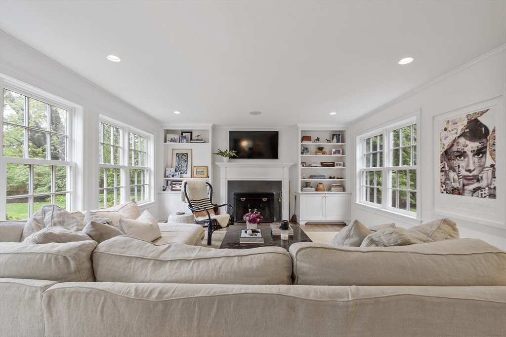 90 Coolidge Road Concord, MA 01742 - Photo 5 of 42 a living room with furniture a fireplace and a large window
