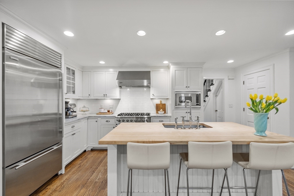 90 Coolidge Road Concord, MA 01742 - Photo 6 of 42 a kitchen with appliances a sink and cabinets