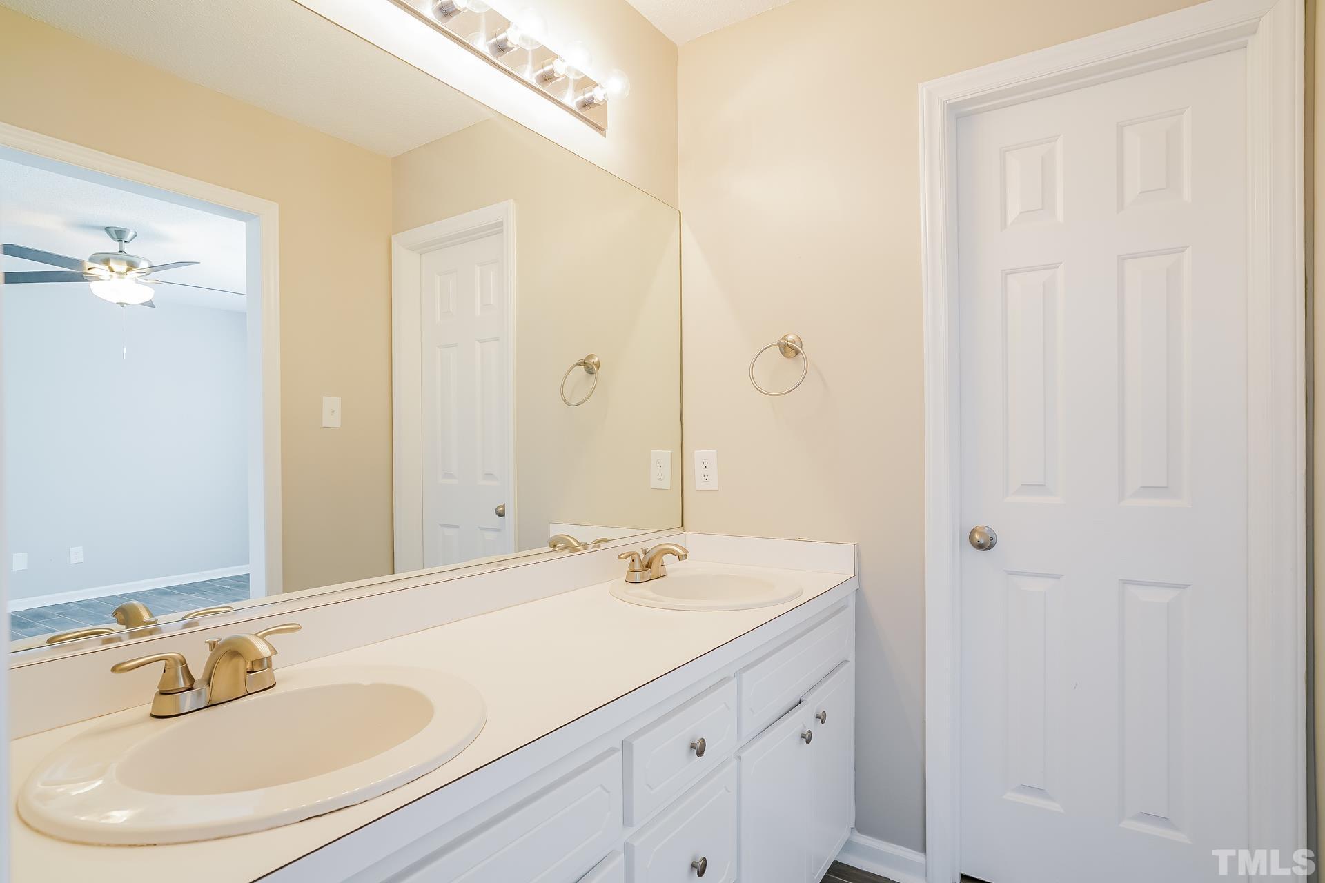 110 Impressive Lane Clayton, NC 27520 - Photo 14 of 16 a bathroom with a sink and a mirror