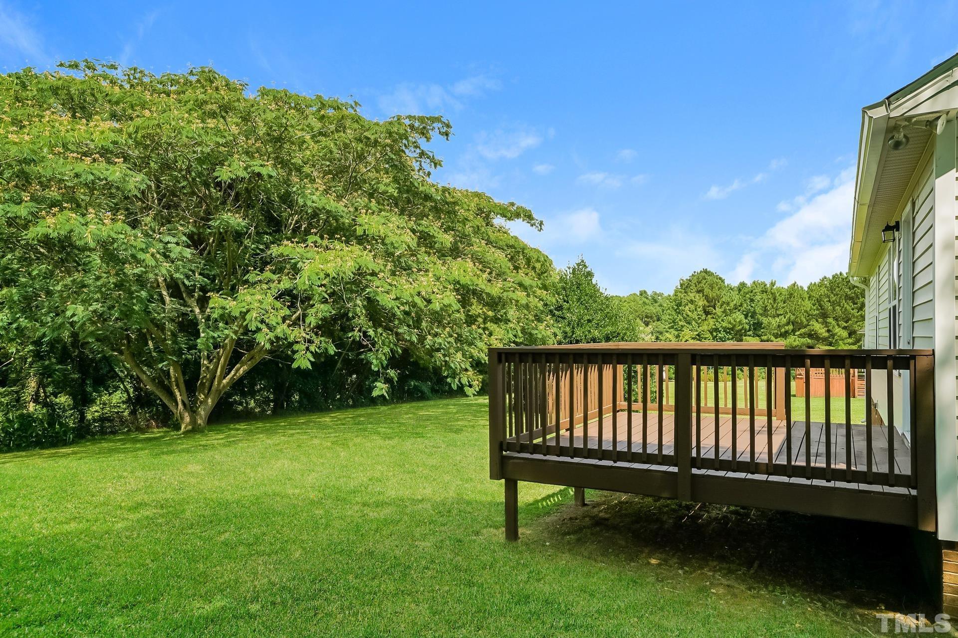110 Impressive Lane Clayton, NC 27520 - Photo 15 of 16 a view of a backyard with a garden