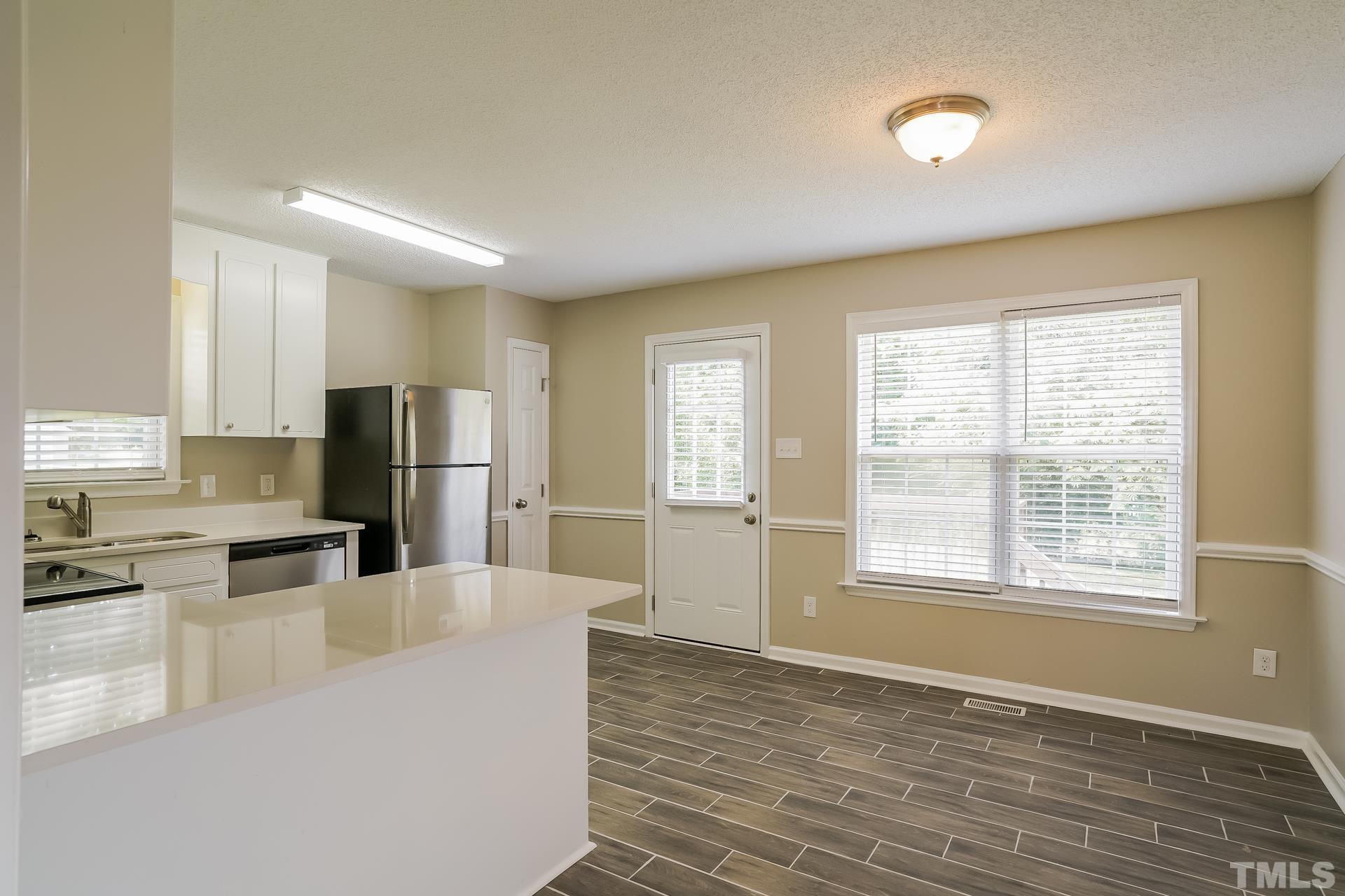110 Impressive Lane Clayton, NC 27520 - Photo 6 of 16 a kitchen with stainless steel appliances a refrigerator and a stove top oven