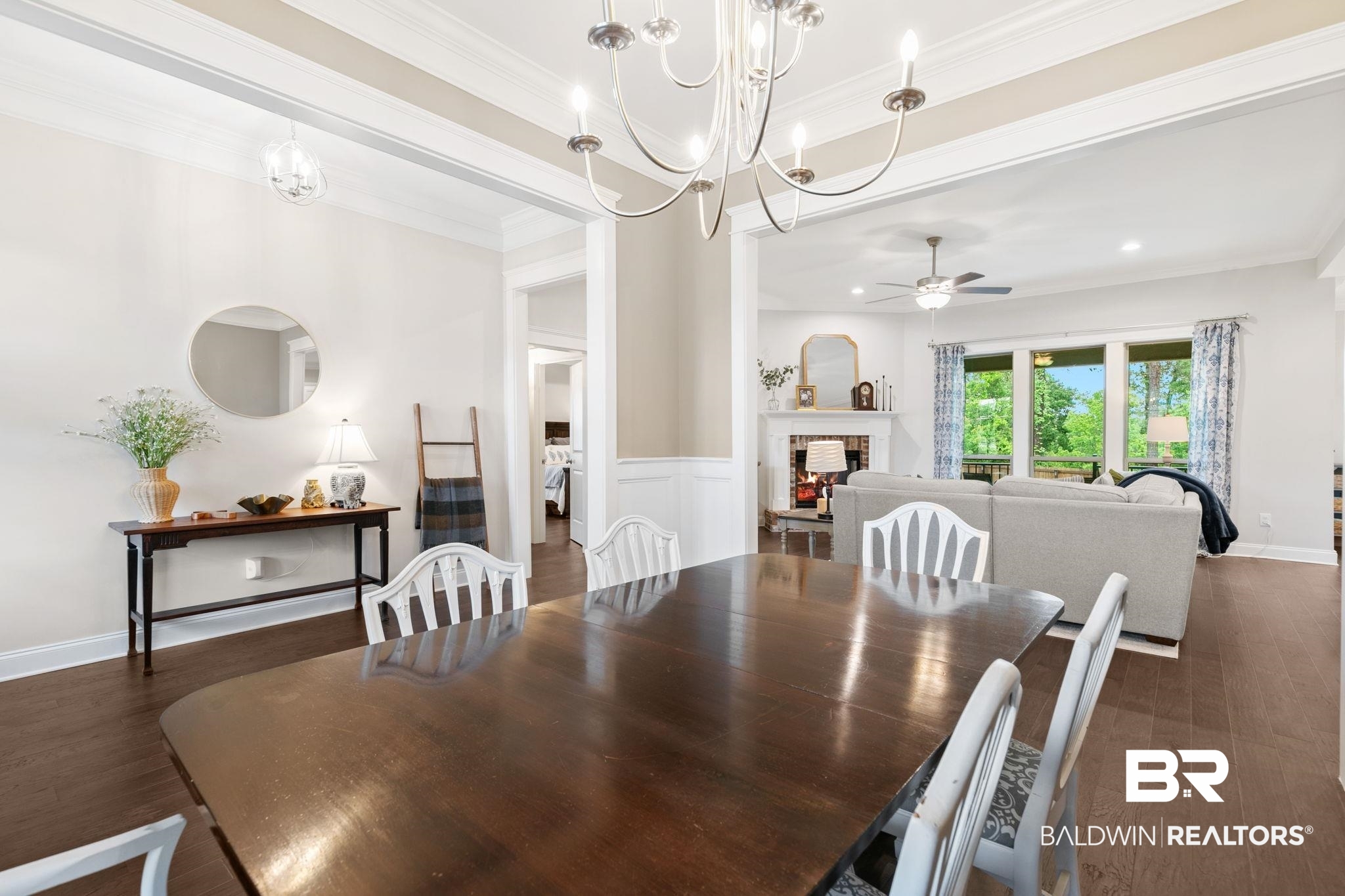 13233 Ibis Boulevard Daphne, AL 36527 - Photo 11 of 100 Spacious dining area featuring wood-finish flooring, a decorative chandelier, and an open entryway to the living room