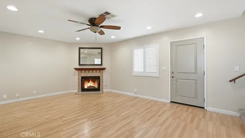 an empty room with windows and a fireplace