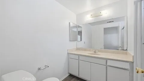a bathroom with a sink mirror and toilet