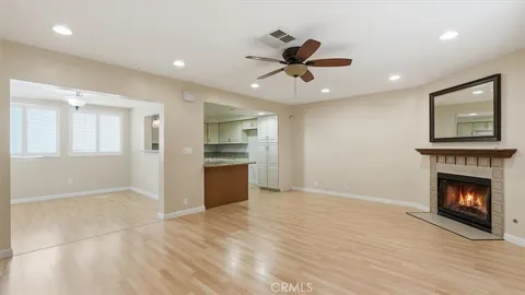 a view of an empty room with a fireplace and a window