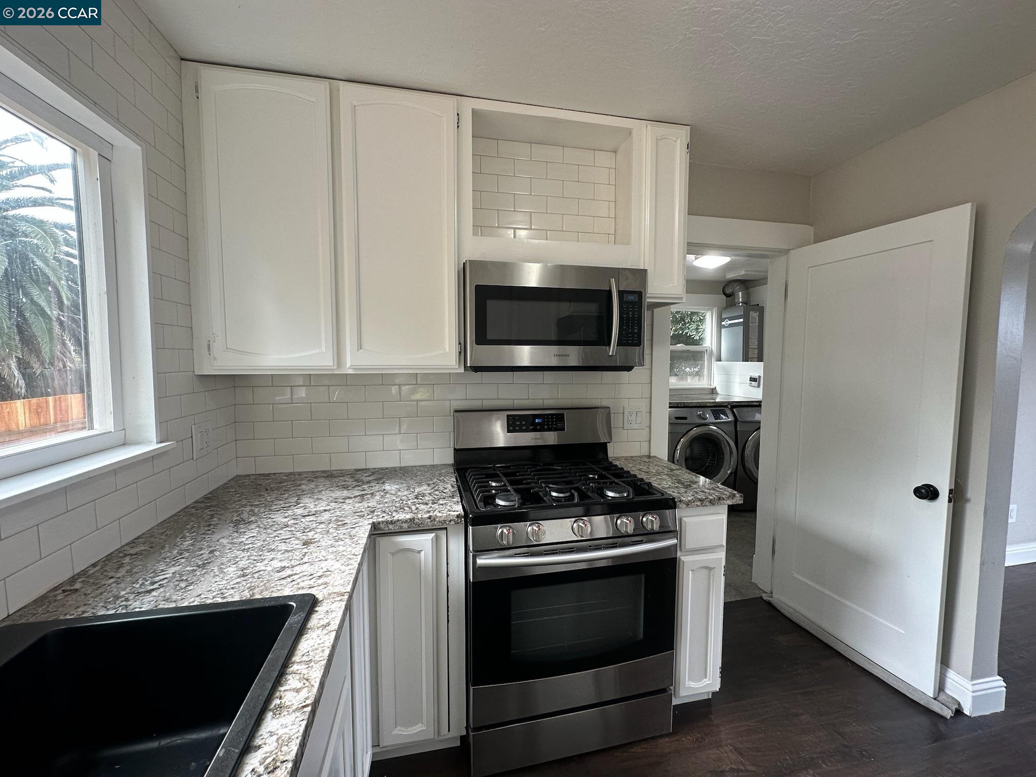 315 West 3rd Street, Unit B Antioch, CA 94509 - Photo 15 of 41 a kitchen with stainless steel appliances white cabinets and a stove top oven