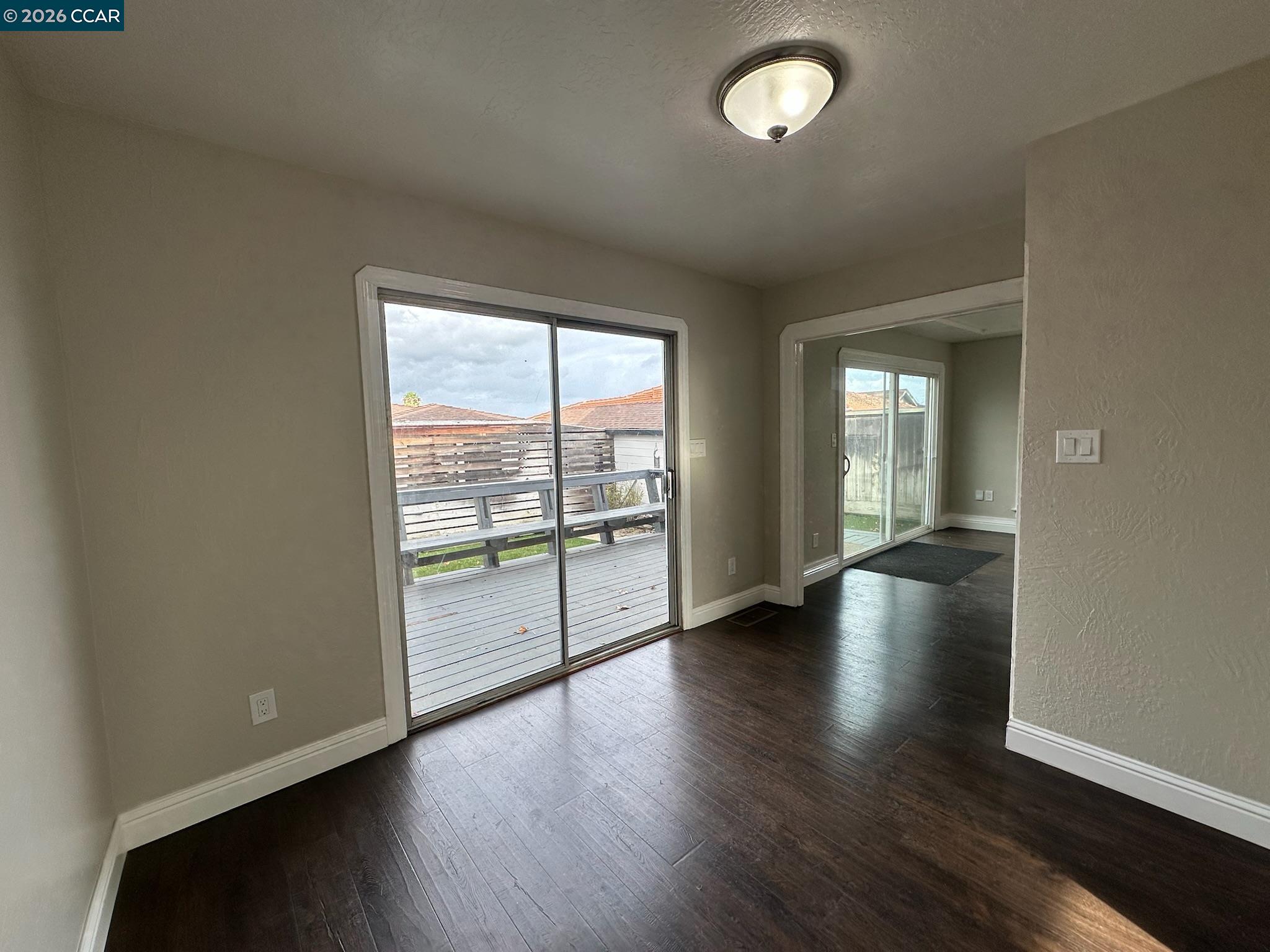 315 West 3rd Street, Unit B Antioch, CA 94509 - Photo 19 of 41 an empty room with wooden floor and windows