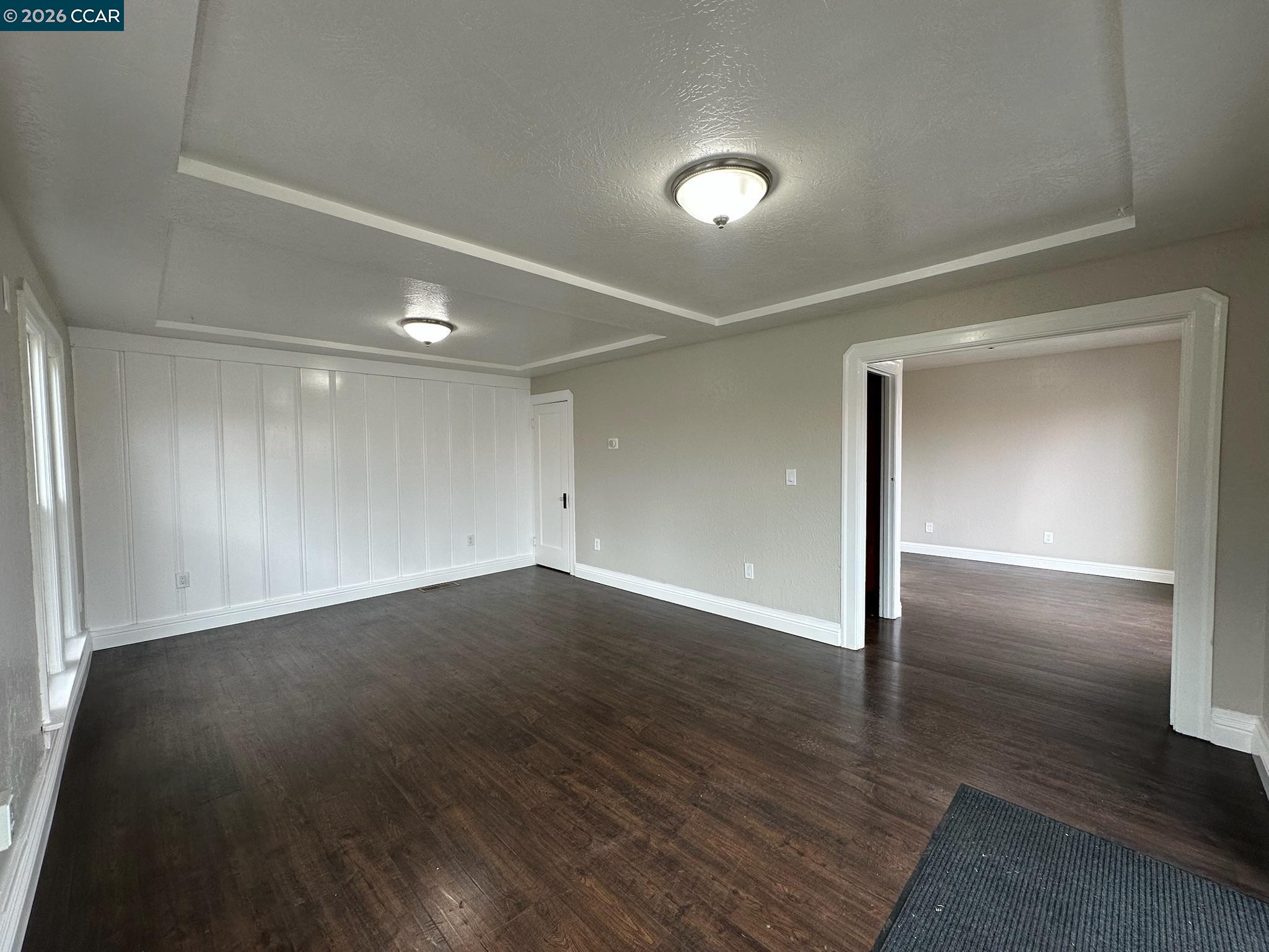 315 West 3rd Street, Unit B Antioch, CA 94509 - Photo 20 of 41 an empty room with wooden floor & windows