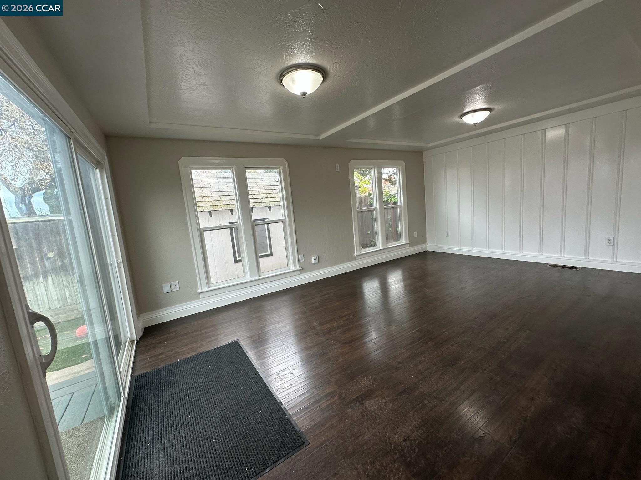 315 West 3rd Street, Unit B Antioch, CA 94509 - Photo 24 of 41 an empty room with wooden floor and windows