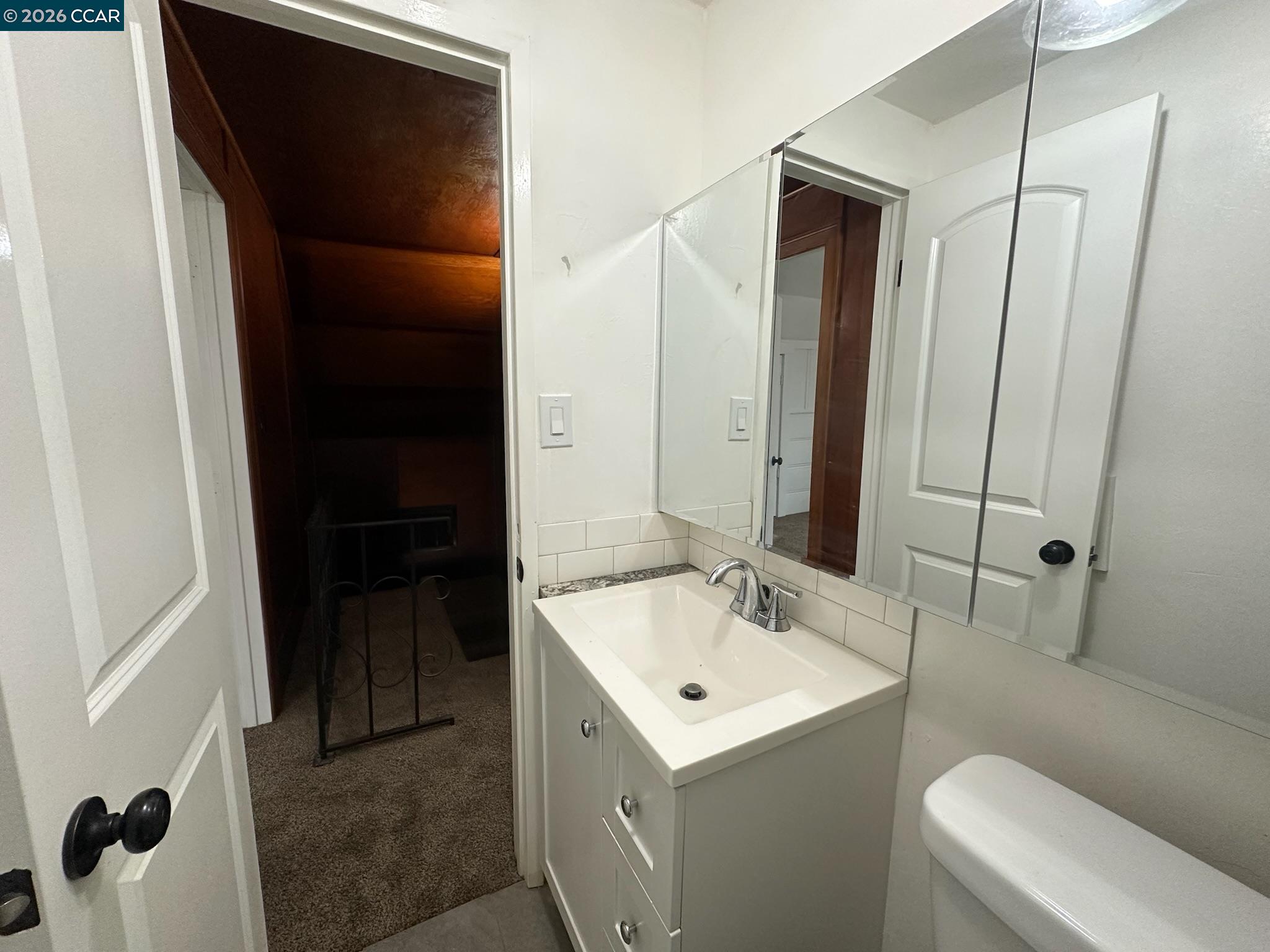 315 West 3rd Street, Unit B Antioch, CA 94509 - Photo 27 of 41 a bathroom with a sink and mirror with toilet