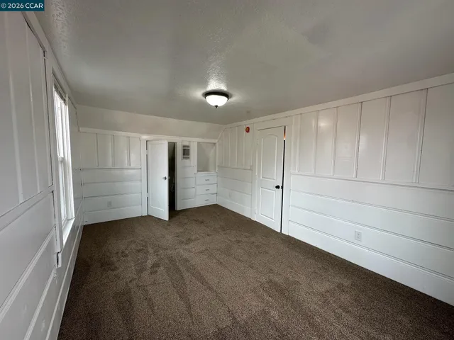 an empty room with a empty space and windows