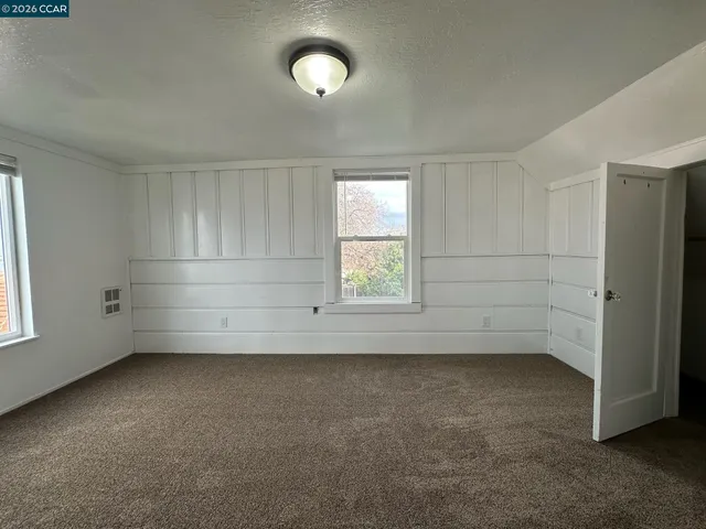 an empty room with a empty space and windows