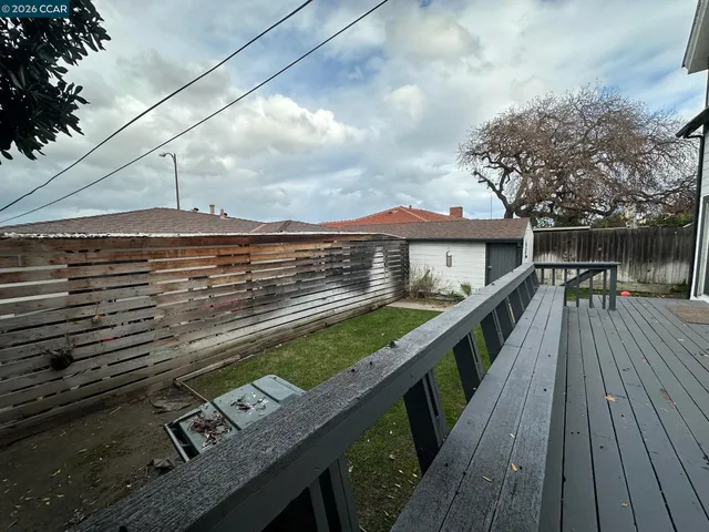 a view of a roof deck with wooden floor and fence