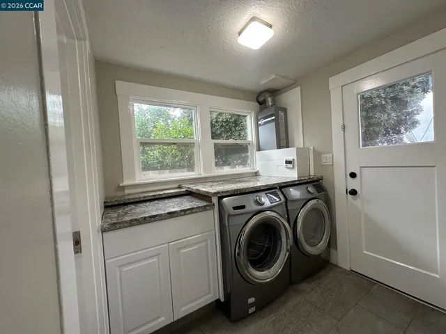 a utility room with sink dryer and washer