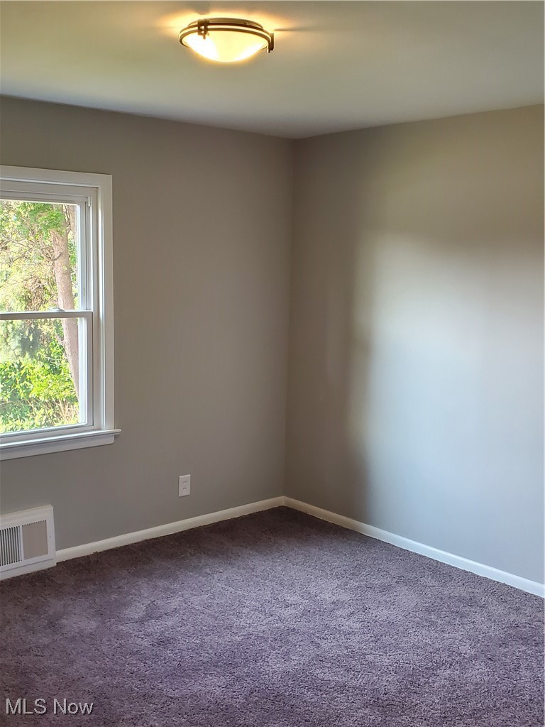 7007 Biddulph Road Brooklyn, OH 44144 - Photo 9 of 16 Empty room with dark carpet and baseboards