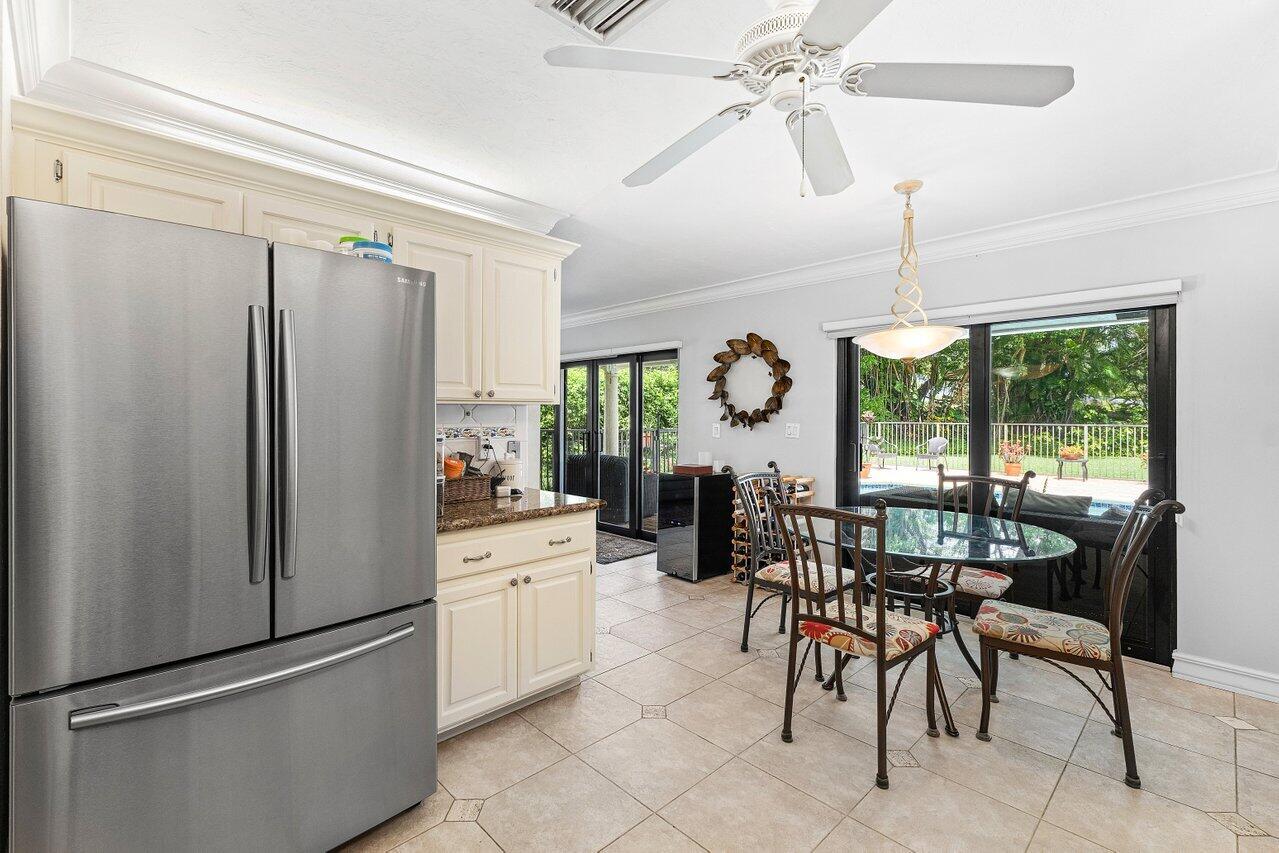 3523 Pine Haven Circle Boca Raton, FL 33431 - Photo 15 of 42 a kitchen with stainless steel appliances kitchen island granite countertop furniture and a refrigerator