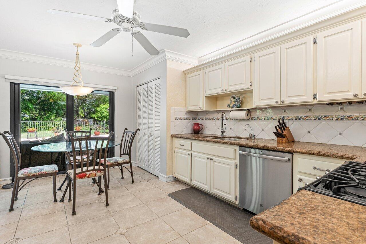 3523 Pine Haven Circle Boca Raton, FL 33431 - Photo 16 of 42 a kitchen with stainless steel appliances granite countertop sink stove and white cabinets with wooden floor