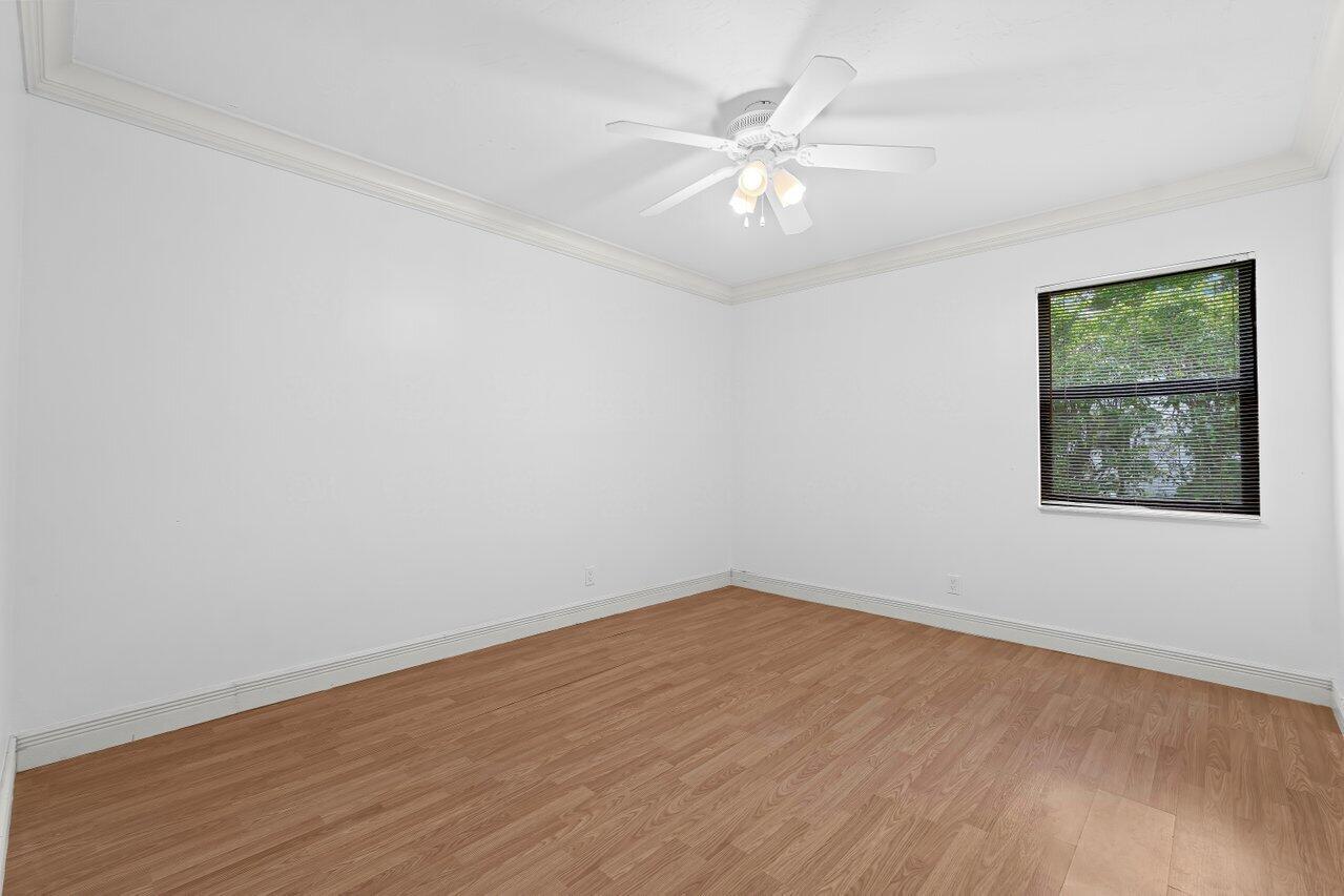3523 Pine Haven Circle Boca Raton, FL 33431 - Photo 22 of 42 an empty room with wooden floor and windows