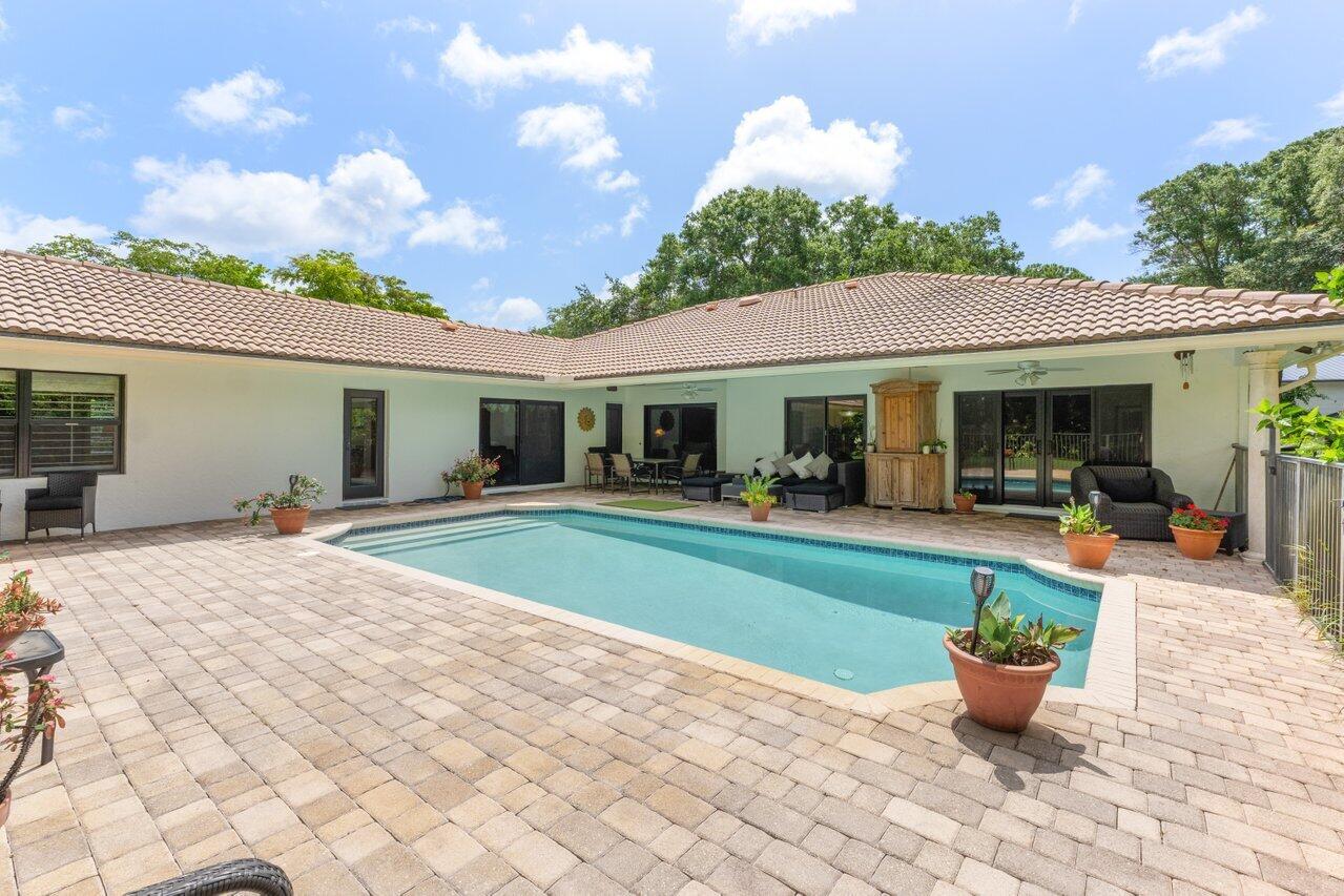 3523 Pine Haven Circle Boca Raton, FL 33431 - Photo 26 of 42 a view of a house with backyard sitting area and garden