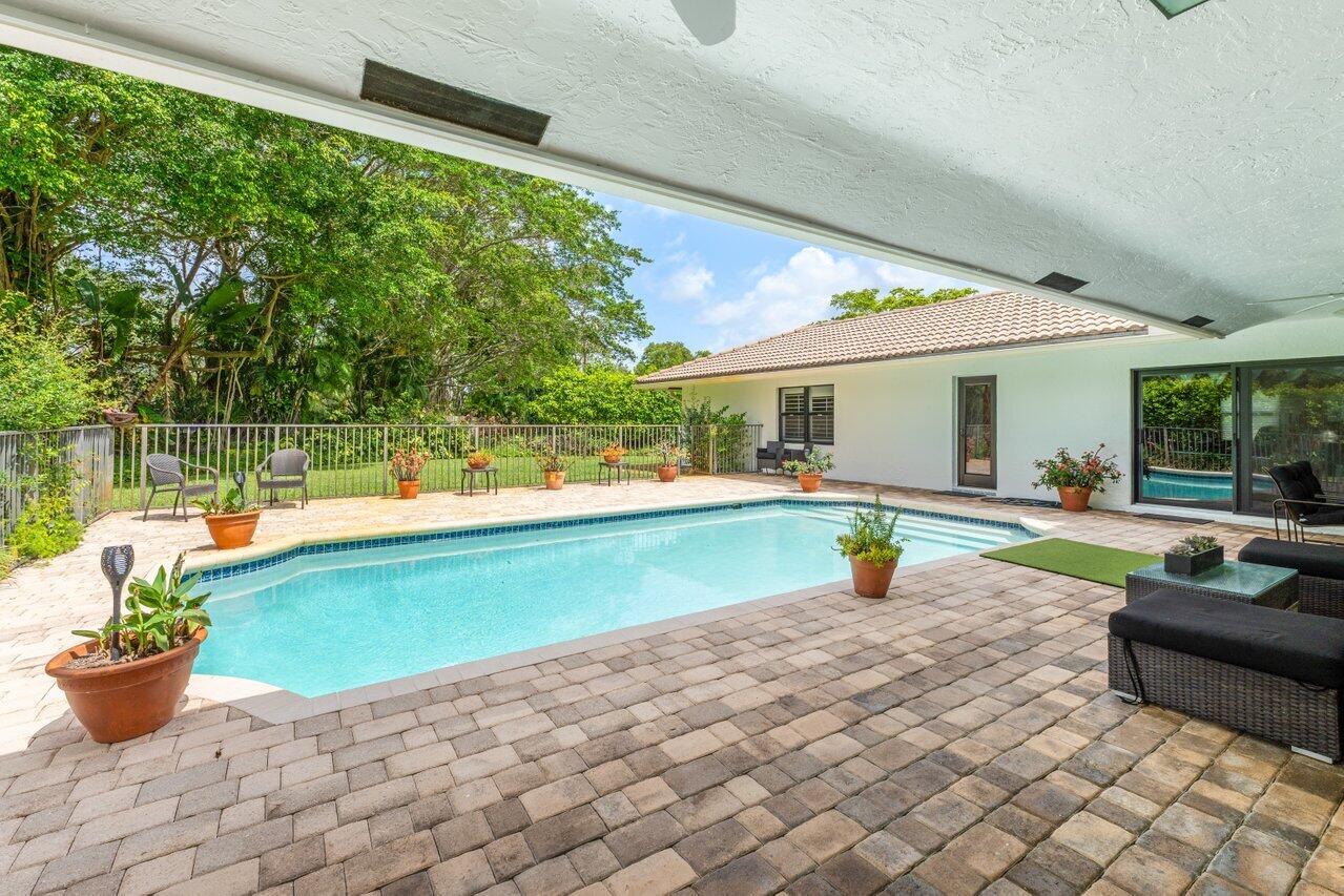 3523 Pine Haven Circle Boca Raton, FL 33431 - Photo 27 of 42 a view of a swimming pool with a lounge chair