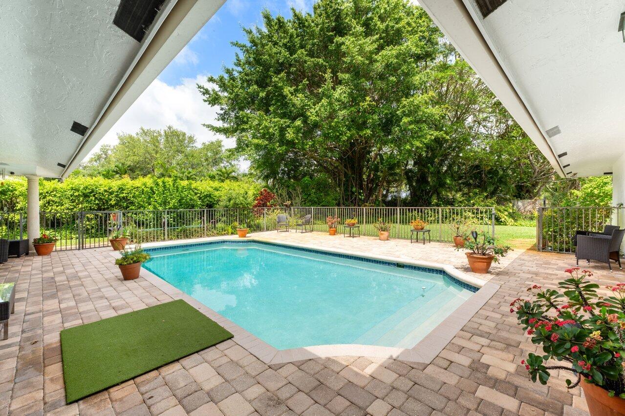 3523 Pine Haven Circle Boca Raton, FL 33431 - Photo 28 of 42 a view of a swimming pool with a lounge chair