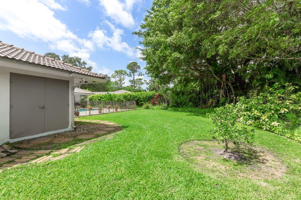 3523 Pine Haven Circle Boca Raton, FL 33431 - Photo 32 of 42 a backyard of a house with plants and large trees
