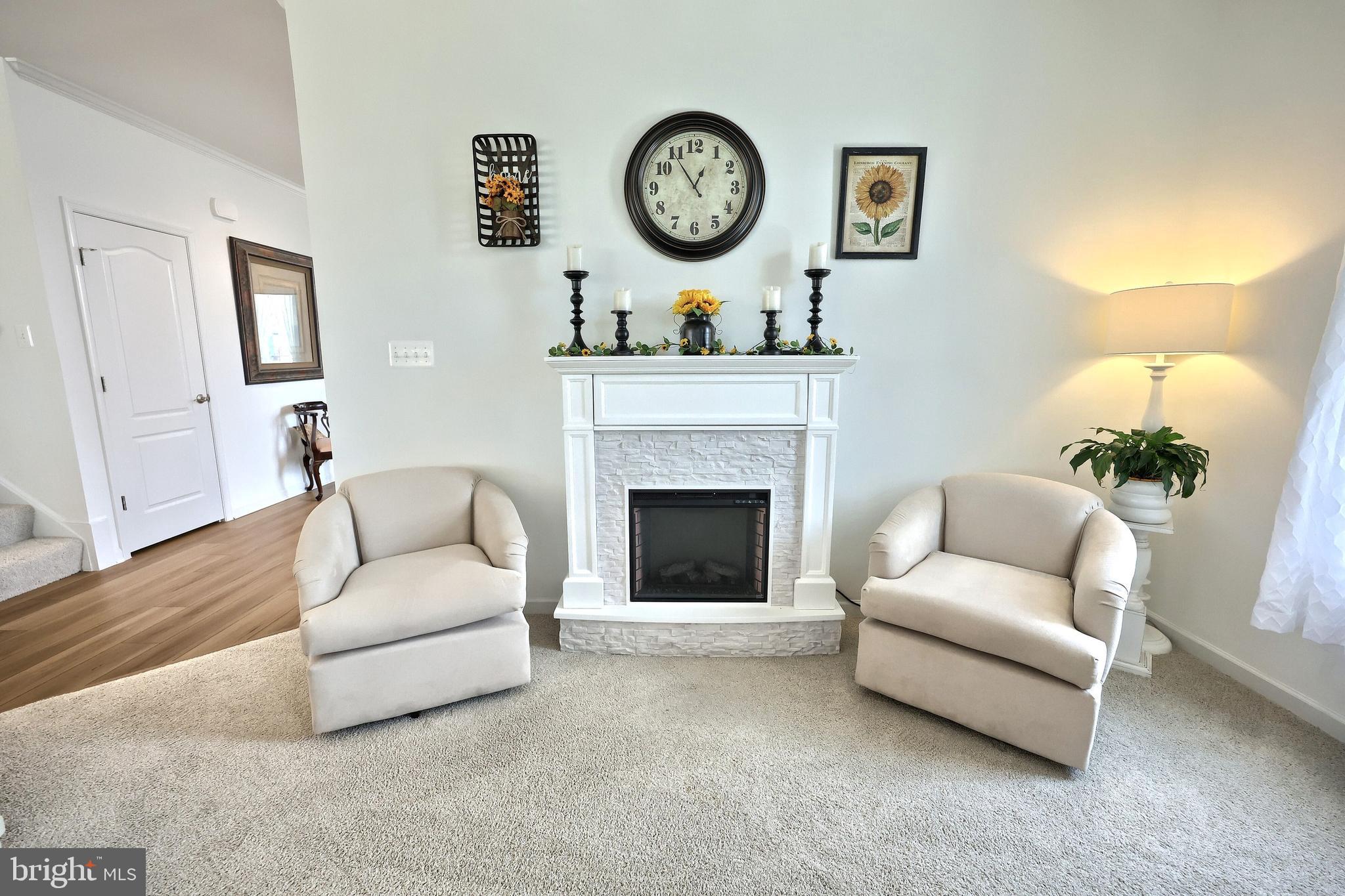 130 Pheasant Ridge Road Hanover, PA 17331 - Photo 13 of 59 a living room with furniture a clock and a fireplace