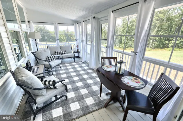 a view of a dining room with furniture wooden floor and garden view