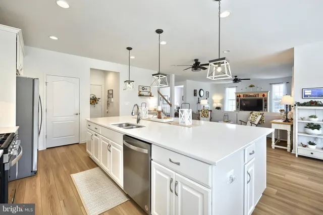 a kitchen with appliances a sink and cabinets
