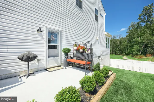 an aerial view of a house with garden space and ocean view