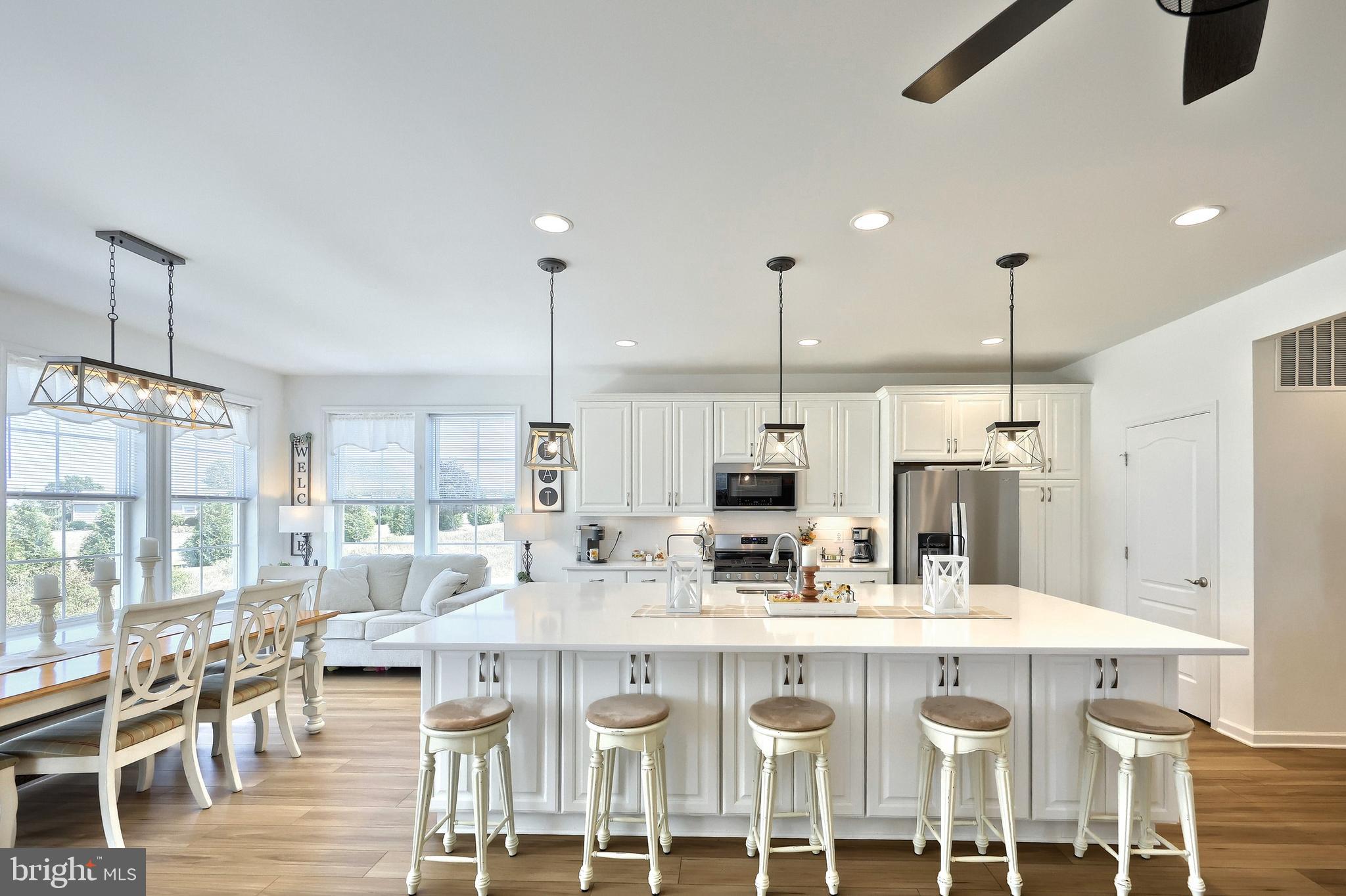 130 Pheasant Ridge Road Hanover, PA 17331 - Photo 5 of 59 a kitchen with stainless steel appliances kitchen island granite countertop a dining table chairs and white cabinets