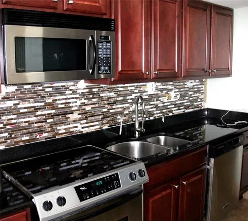 a kitchen with granite countertop a stove and a sink