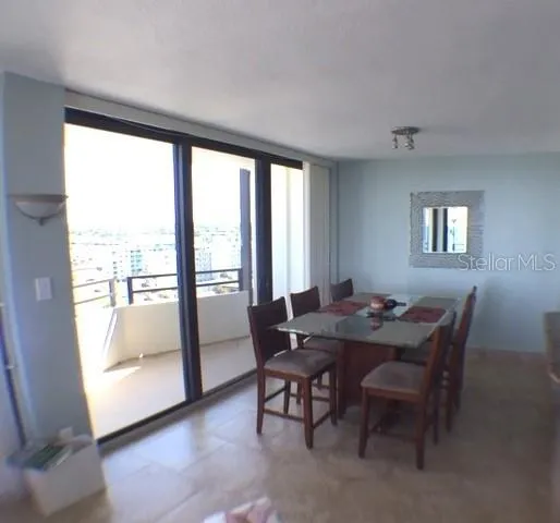a view of a dining room with furniture and a window