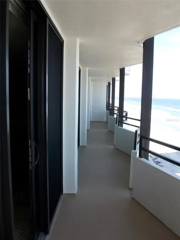 a view of a hallway with furniture and natural light