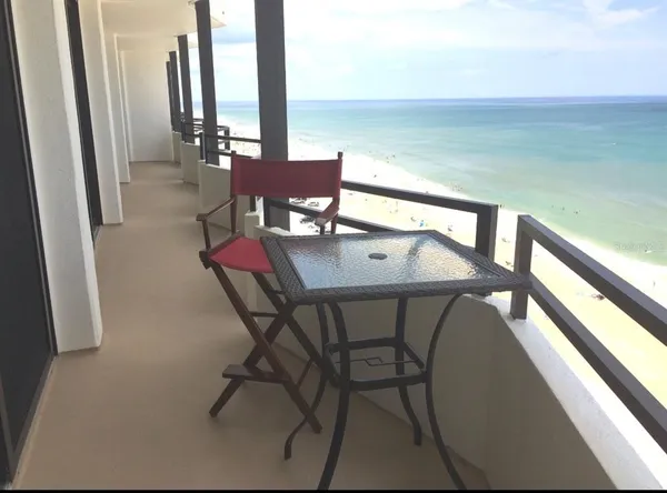 a view of a chairs and table in the balcony