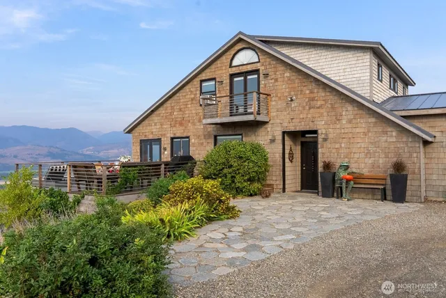 a view of a house with a yard and lawn chairs
