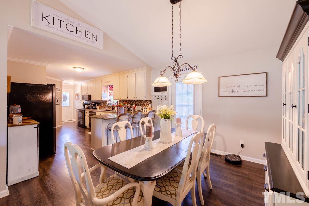 9622 Sawyer Road Rougemont, NC 27572 - Photo 11 of 34 a view of a dining room with furniture wooden floor and chandelier