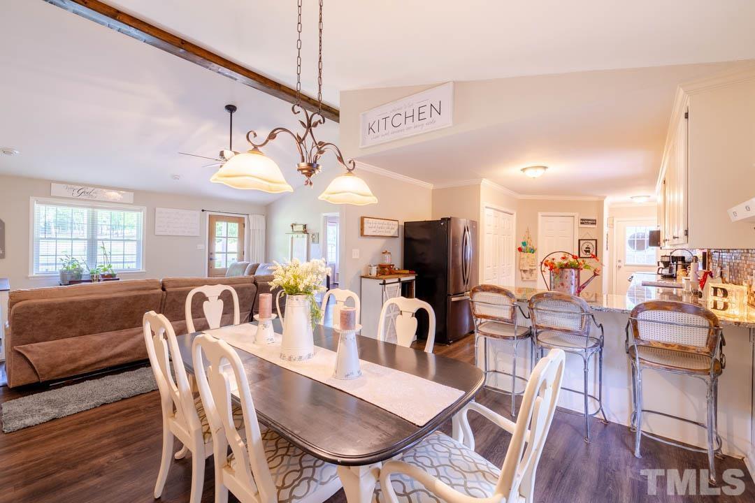 9622 Sawyer Road Rougemont, NC 27572 - Photo 12 of 34 a view of a dining room with furniture window and wooden floor