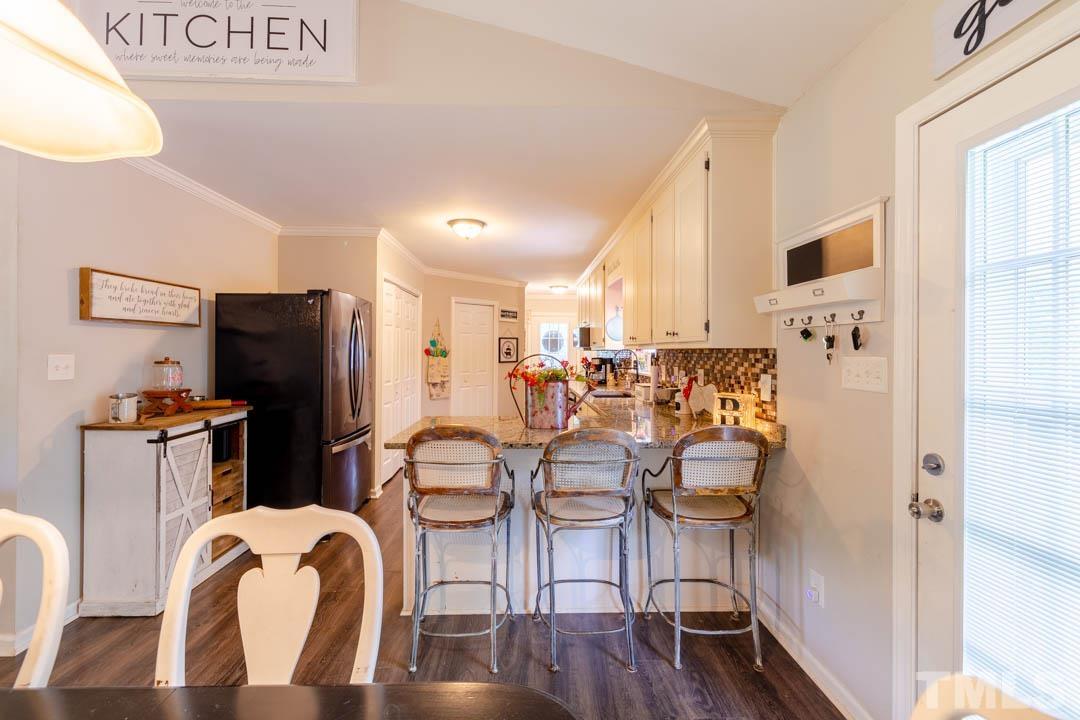 9622 Sawyer Road Rougemont, NC 27572 - Photo 13 of 34 a kitchen with stainless steel appliances a refrigerator and wooden floor