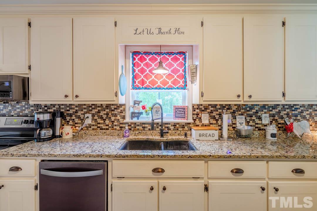 9622 Sawyer Road Rougemont, NC 27572 - Photo 16 of 34 a kitchen with stainless steel appliances granite countertop a sink a stove and cabinets